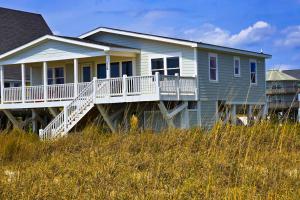 a house with a porch and a deck at HB21 Austin Cottage in Holden Beach