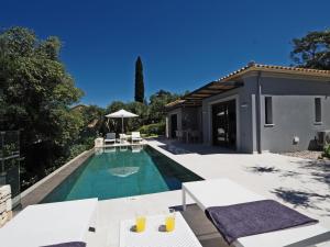 a villa with a swimming pool and a house at Gaia by Vintage Travel in Ágios Dimítrios