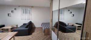a living room with a couch and a table at A6 Apartment in Kirchardt