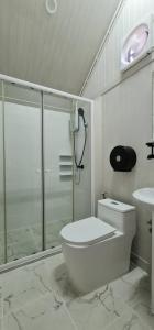 a bathroom with a shower and a toilet and a sink at Fill up mini home in Nong Prue +51 photos