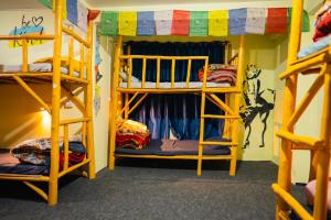 a room with three bunk beds in it at Hostel 360 Degree in Manāli