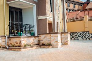 a building with a balcony with plants on it at Peacefull home Too in Kampala