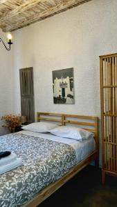 a bedroom with a wooden bed with at Vougli View Mykonos in Drafaki