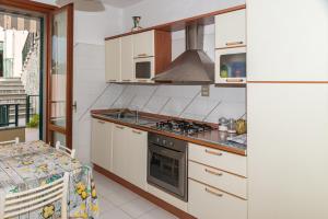 a kitchen with a stove top oven next to a refrigerator at Monterosso view apartment 5 Terre in Monterosso al Mare +25 photos