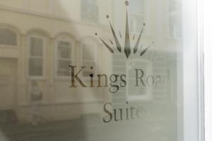 a window with the words kings road sire in front of a house at Kings Road Suites in Brighton & Hove