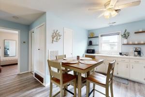 a kitchen and dining room with a table and chairs at Dockside Daydreamin' in Ocean City