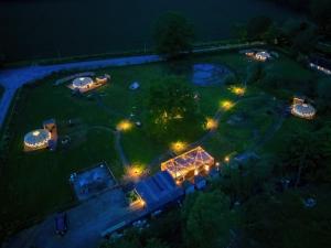 an aerial view of a garden at night with lights at Glamp and Tipple Ltd in Great Ellingham