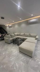 ein Wohnzimmer mit einem Sofa und einem Tisch in der Unterkunft درة العروس فيلا بشاطئ رملي خاص in Durrat Al-Arus