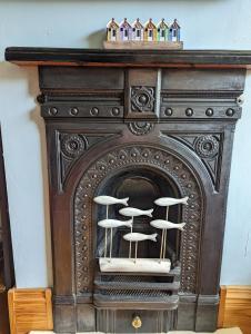 an old fireplace with two stools in it at Clearsands Mablethorpe in Mablethorpe
