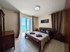 a bedroom with a bed and a large window at Villa Rosalia in Coral Bay +55 photos