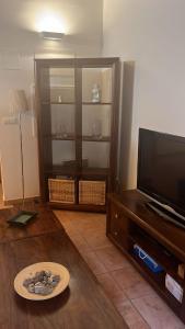 a living room with a television and a table at Zara Villanúa in Villanúa +16 photos