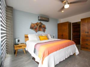 a bedroom with a large bed with a wooden headboard at Casa Bella Luna in Cabo San Lucas