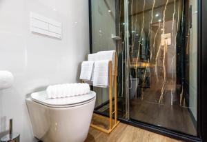 a white bathroom with a shower and a toilet at São João Alojamento in Gavião