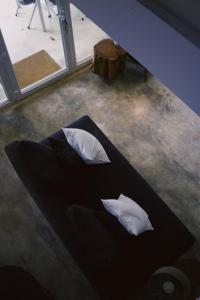 a black bed with two white pillows on the floor at Casa Oliva - Casa da Mata in Porto de Mós +64 photos