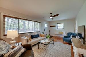 a living room with a couch and a table at Lake Michigan Getaway Walk to Beach and Golf! in Muskegon