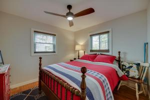 a bedroom with a bed and a ceiling fan at Lake Michigan Getaway Walk to Beach and Golf! in Muskegon