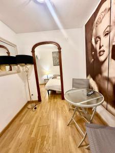 a room with a table and a large painting on the wall at Borne rooms in Barcelona