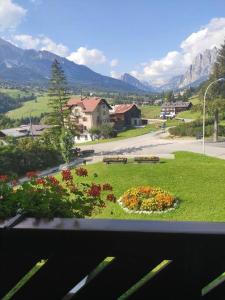 a view from a window of a park with benches at Villa 5 Torri in Cortina dʼAmpezzo