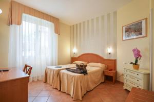 Posteľ alebo postele v izbe v ubytovaní Hotel Katy