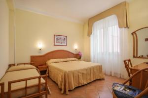 Posteľ alebo postele v izbe v ubytovaní Hotel Katy