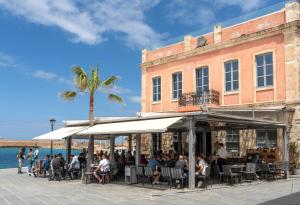 a group of people sitting outside of a building at Hanim Boutique Hotel in Chania Town