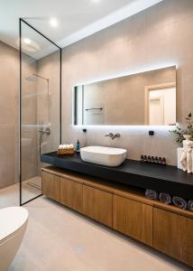 a bathroom with a sink and a mirror at Ioannina Secret Luxury Villas in Ioannina