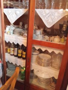 a cabinet full of dishes and plates in a room at house FYNTIKAKH - SKALA in Anopoli Sfakion