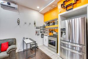 a kitchen with a stainless steel refrigerator and a table at 7 Mi to Downtown Dallas WFH-Friendly Studio in Dallas