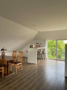 a kitchen and dining room with a table and chairs at Penthouse Langenloiserberg in Krems an der Donau