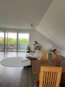 a living room with a couch and a table at Penthouse Langenloiserberg in Krems an der Donau