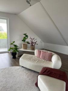 a living room with a couch in a attic at Penthouse Langenloiserberg in Krems an der Donau