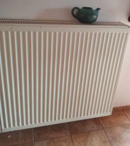 a radiator against a wall with a vase on it at house FYNTIKAKH - SKALA in Anopoli Sfakion