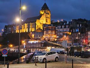 a white car parked in a parking lot in front of a building at Le Saint Julien in Le Tréport