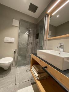 a bathroom with a sink and a shower at Pension Moarhof in Feldthurns