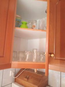 a cupboard with many glass dishes in it at house FYNTIKAKH - SKALA in Anopoli Sfakion