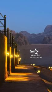 a pathway in the desert at night with lights at RUM ATANA lUXURY CAMP in Wadi Rum