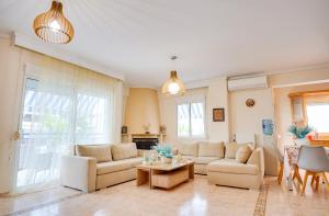 a living room with two couches and a table at LOVELY AND SUNNY APARTAMENT 300m FROM BEACH!! in Perea