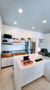 a kitchen with a white counter in a room at Finca acogedora en Villeta con piscina privada in Villeta