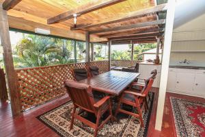 a dining room with a table and chairs on a balcony at Ryan's Rest Boutique Accommodation in Cairns