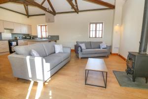 a living room with a couch and a stove at The Granary in Penzance