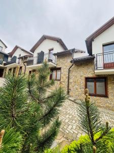 a stone house with trees in front of it at Apartmány Alexander in Vrbov