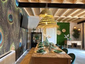 a dining room with a wooden table and a chandelier at Castaños - Casal do Conde in Dimo