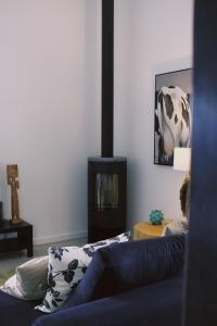 a living room with a couch and a fireplace at Casa Oliva - Casa da Serra in Porto de Mós +55 photos