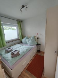 een kleine slaapkamer met een bed en een raam bij HOG Apartment Nürnberg St. Peter in Neurenberg