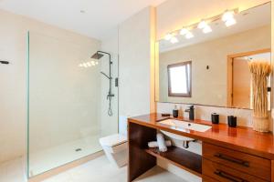 a bathroom with a sink and a shower and a mirror at Sant Cesc in Ciutadella +31 photos