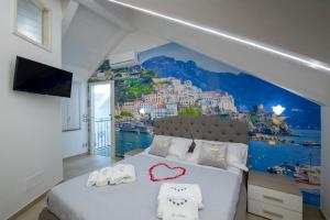 a bedroom with aamicamicamic view of a city at Le 5 Perle in Agerola