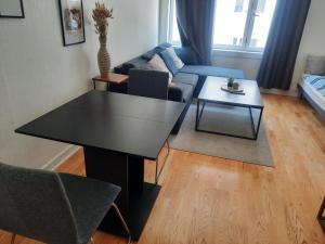 een woonkamer met een zwarte tafel en een bank bij Agi in Oslo