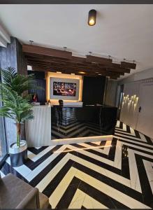 a lobby with a television and a zebra patterned floor at Best House Hotel in Istanbul