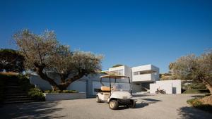 a white golf cart parked in front of a building at Amamia in Saint-Tropez