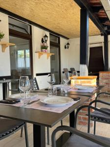 a table with wine glasses on top of it at Hotel Restaurant Sjor Luka Turanj in Turanj
